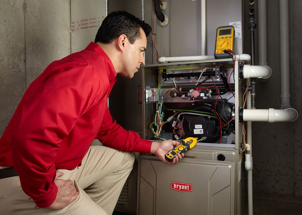 HVAC technician repairing an indoor furnace in Pleasant Grove