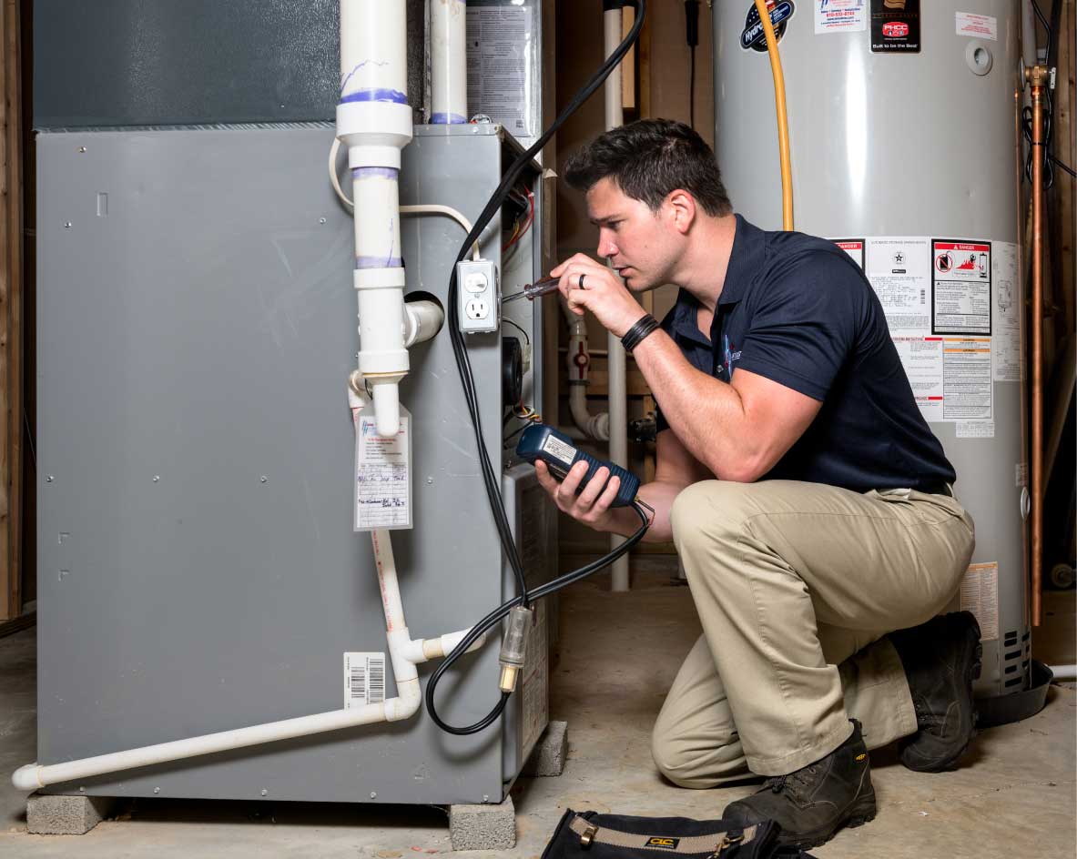 HVAC technician performing a furnace tune-up in Pleasant Grove