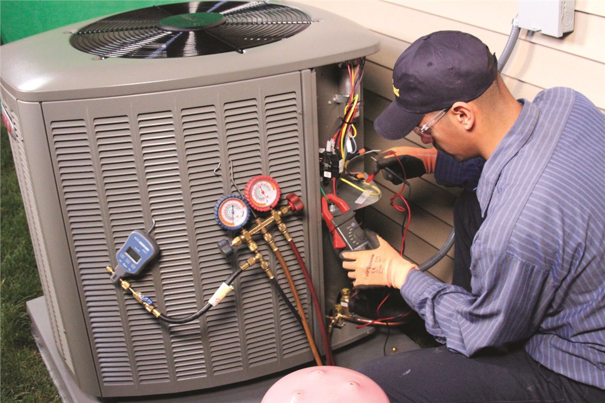 HVAC technician testing an outdoor air conditioning unit in Pleasant Grove