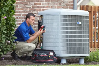 HVAC technician inspecting an outdoor air conditioning unit in Pleasant Grove, UT